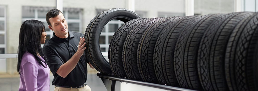 Subaru service representative showing customer a tire. | NADA - Subaru - 2024 in Conway NH